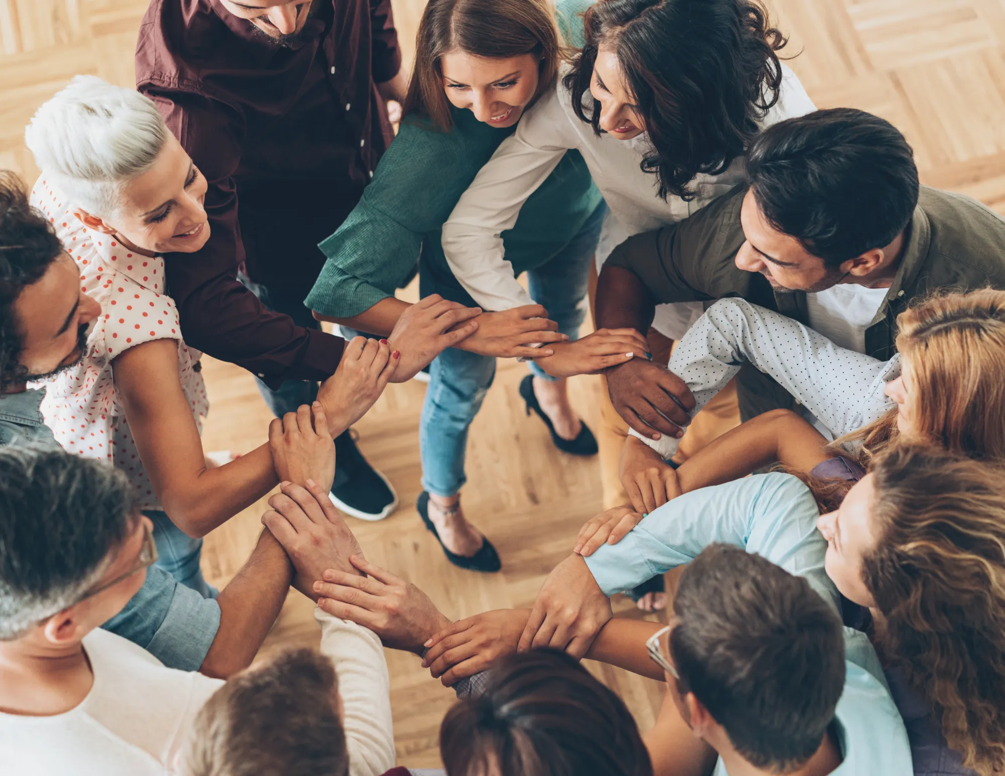 A circle of people with their arms locked together.